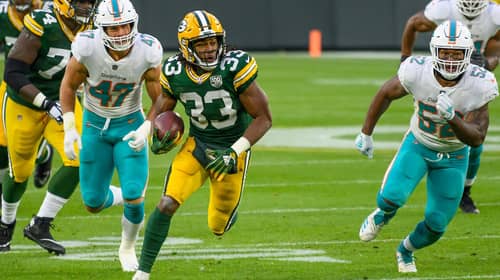 Aaron Jones of the Green Bay Packers runs for a first down in a game against the Miami Dolphins at Lambeau Field, in Green Bay, Wisconsin on November 11, 2018. Photo Credit: Elvis Kennedy | Under Creative Commons License