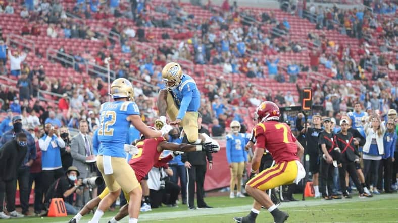 UCLA Football: From The Rosen One to The Great One 2 UCLA Football: UCLA Quarterback Dorian Thompson-Robinson Hurdles A USC Defender. Photo Credit: Jesus Ramirez | UCLA Athletics
