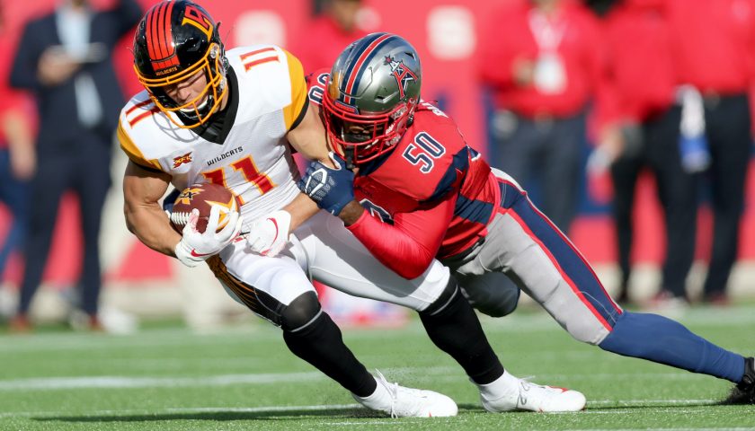 HOUSTON, TX - FEBRUARY 8: LA Wildcats wide receiver Nelson Spruce (11), is tackled by Houston Roughnecks linebacker Kaelin Burnett (50) during action on February 8, 2020 at TDECU Stadium in Houston, Texas. (Photo by Michael Starghill/XFL)