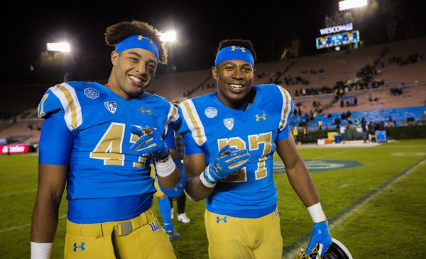 UCLA Bruins linebacker Shea Pitts (47) and running back Joshua Kelley (27) after the game against Cal; Cal at UCLA, November 30, 2019, Los Angeles, CA. Photo Credit: Steve Cheng | Under Creative Commons License